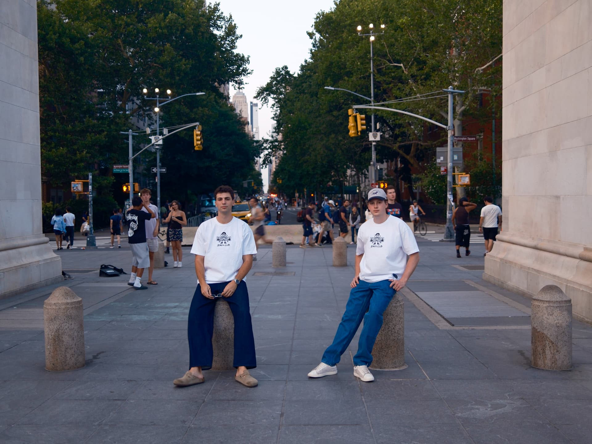 Two people in white Bench Club tees at Washington Square Arch, New York City